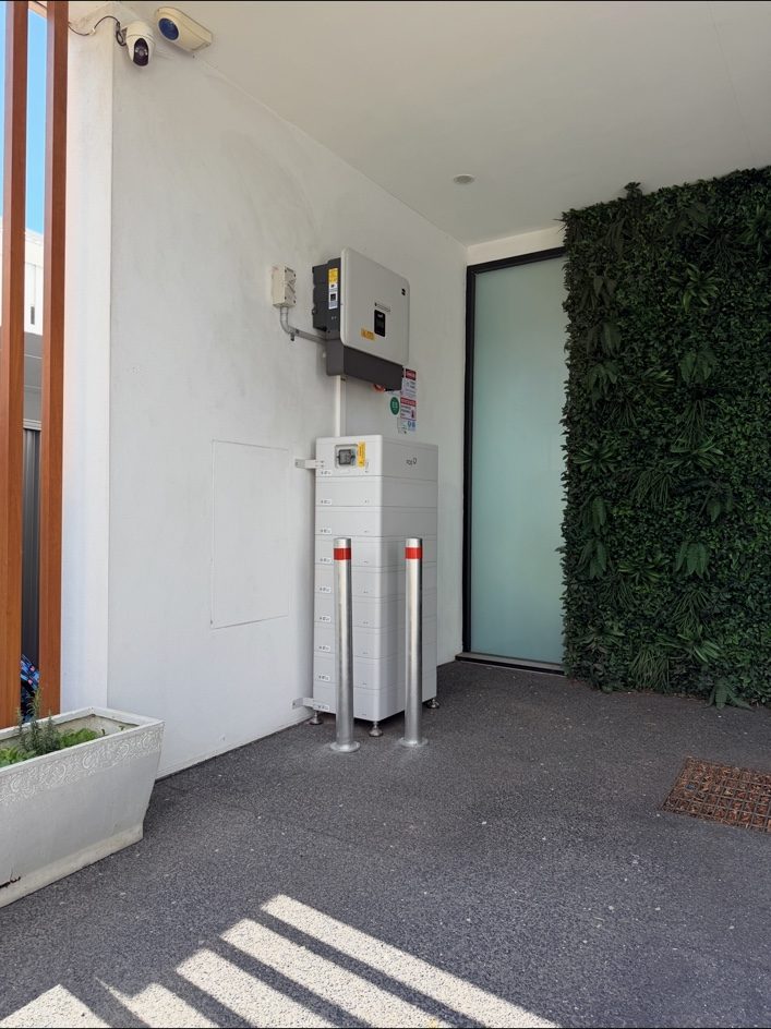A FoxESS battery unit installed on an exterior wall