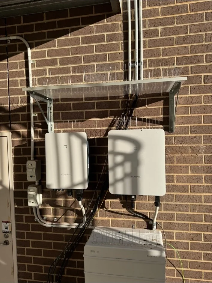 Sungrow battery and inverter equipment mounted on a brick wall