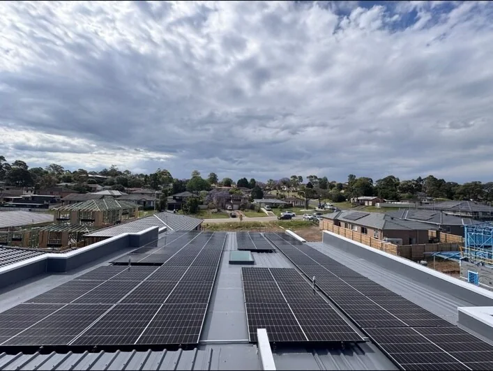 Rows of solar panels installed on a large rooftop